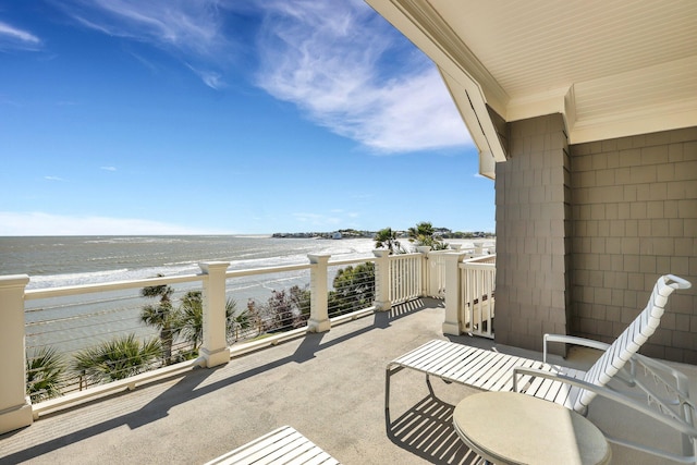 balcony featuring a water view and a view of the beach