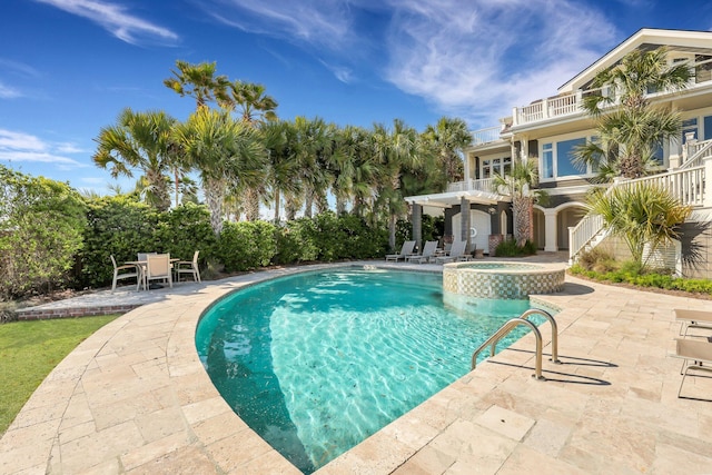 view of swimming pool with a patio area and an in ground hot tub