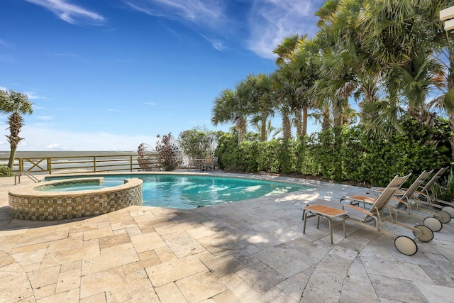 view of pool with an in ground hot tub and a patio area