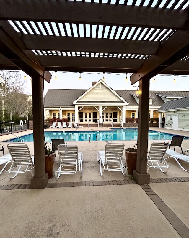 community pool with a patio area and a pergola