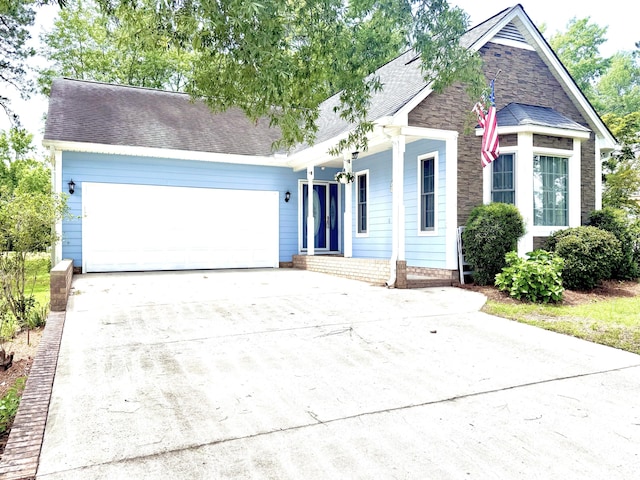 209 Myrtlewood Dr, Santee, SC 29142 - view of front facade with covered porch, an attached garage, driveway, and roof with shingles