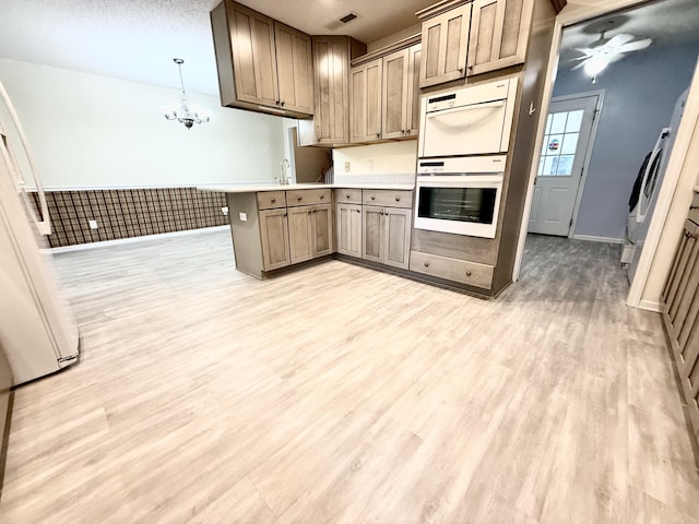209 Myrtlewood Dr, Santee, SC 29142 - kitchen featuring a peninsula, light wood-style floors, double oven, a ceiling fan, and light countertops