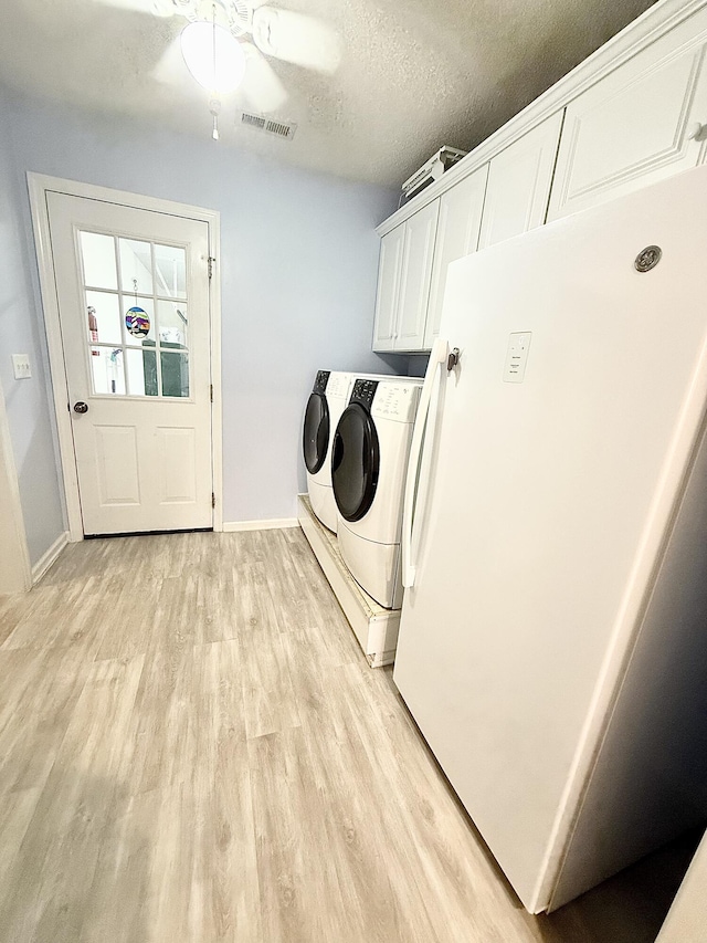 209 Myrtlewood Dr, Santee, SC 29142 - laundry room featuring cabinet space, washing machine and clothes dryer, light wood finished floors, a textured ceiling, and a ceiling fan