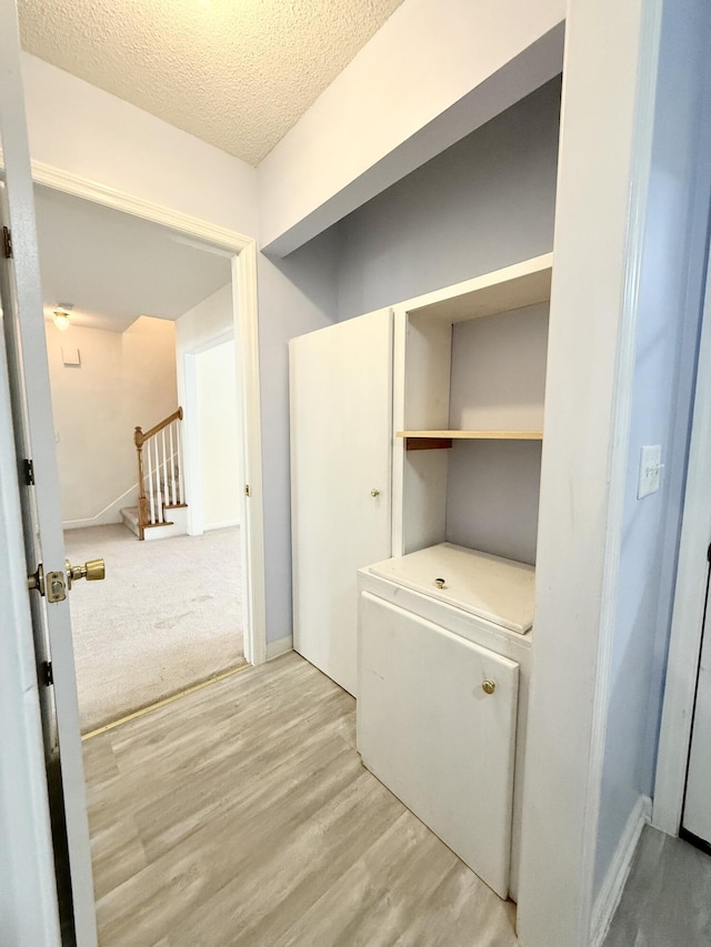 209 Myrtlewood Dr, Santee, SC 29142 - laundry room featuring light wood-style flooring and a textured ceiling