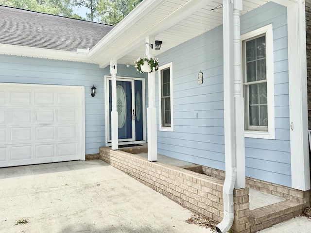 209 Myrtlewood Dr, Santee, SC 29142 - view of exterior entry featuring roof with shingles, a porch, an attached garage, and concrete driveway