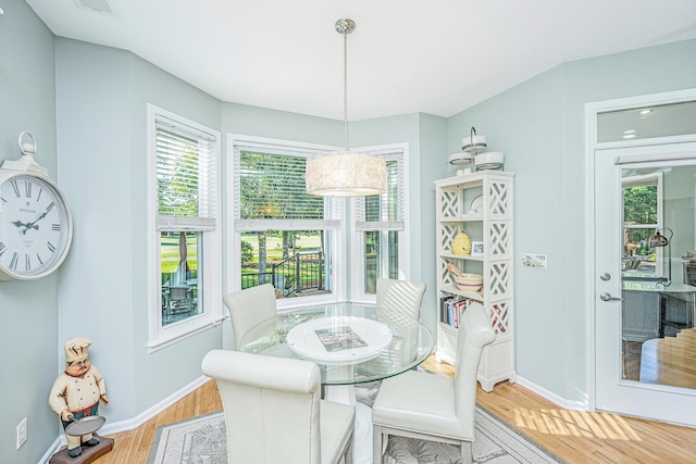dining area with baseboards and light wood finished floors