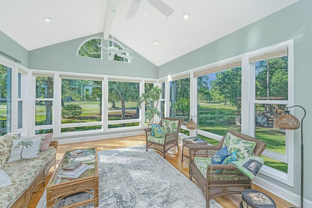 sunroom / solarium featuring vaulted ceiling with beams, a ceiling fan, and a healthy amount of sunlight