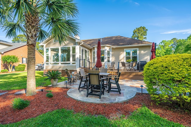 view of patio featuring a sunroom