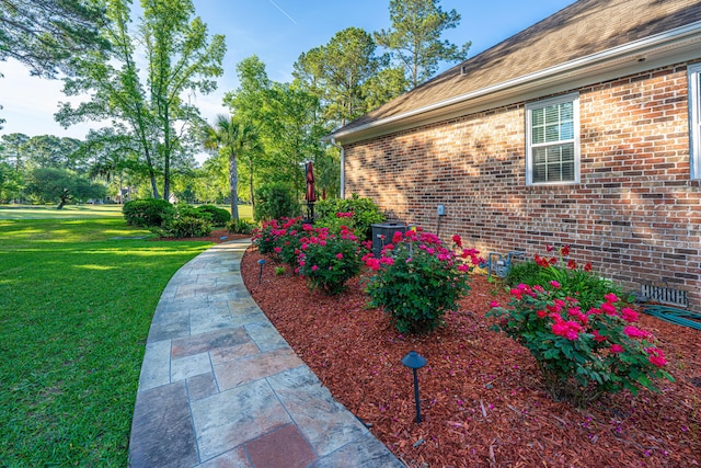 view of home's exterior featuring a yard and brick siding