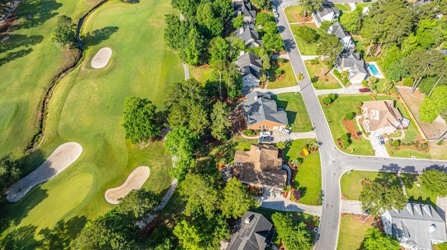 drone / aerial view featuring view of golf course and a residential view