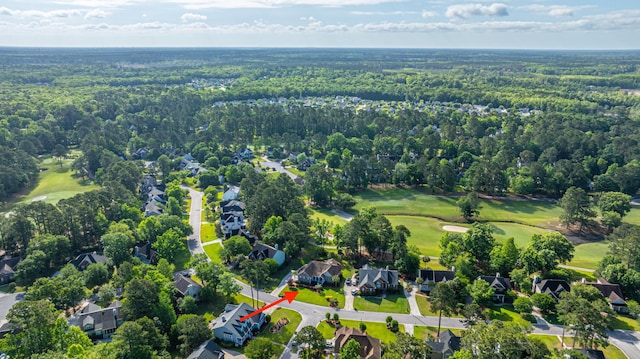 aerial view with view of golf course, a residential view, and a forest view