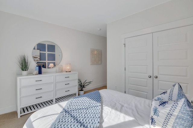 bedroom with light colored carpet and a closet