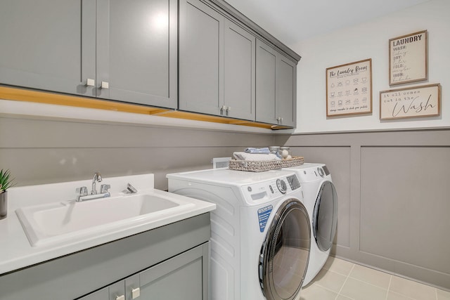 washroom with washer and clothes dryer, cabinets, and sink