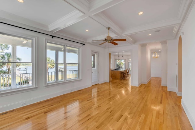 unfurnished room featuring light wood-type flooring, beam ceiling, coffered ceiling, crown molding, and ceiling fan