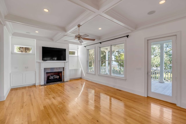 unfurnished living room with light hardwood / wood-style flooring, a wealth of natural light, and ceiling fan