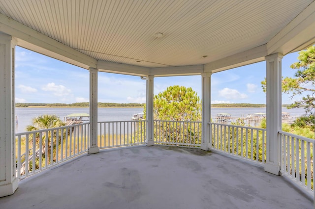 view of patio featuring a porch and a water view