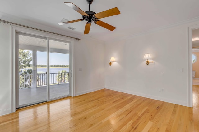 spare room featuring crown molding, hardwood / wood-style floors, and ceiling fan