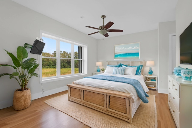 bedroom featuring light hardwood / wood-style flooring and ceiling fan