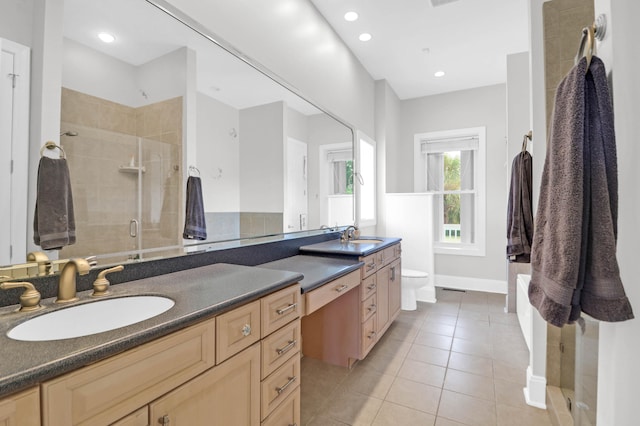 bathroom with vanity, toilet, an enclosed shower, and tile patterned floors