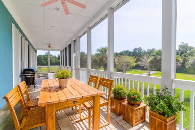 sunroom / solarium featuring ceiling fan