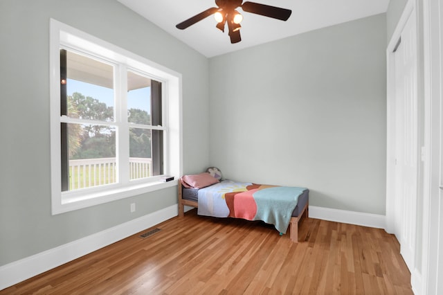 bedroom with ceiling fan and light hardwood / wood-style flooring