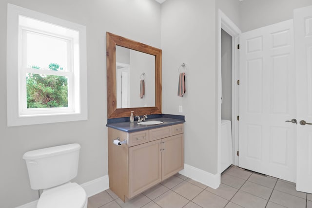 bathroom with vanity, toilet, and tile patterned floors