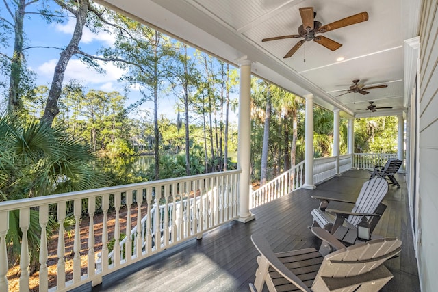 deck with ceiling fan and covered porch