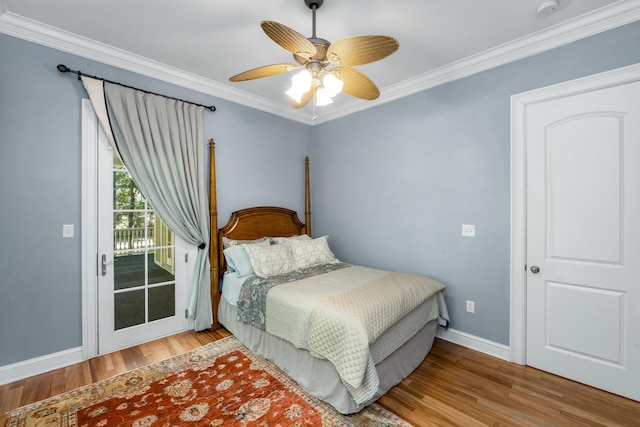 bedroom featuring access to exterior, light wood-style floors, crown molding, and baseboards