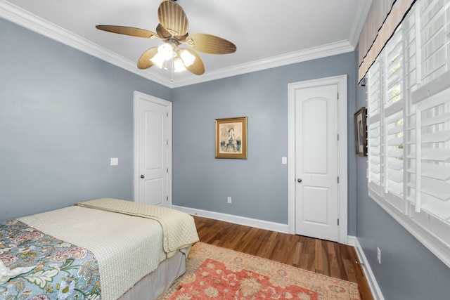 bedroom featuring baseboards, ornamental molding, ceiling fan, and wood finished floors