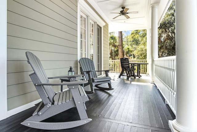 wooden deck featuring a porch and a ceiling fan