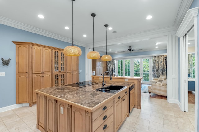 kitchen featuring a center island with sink, hanging light fixtures, glass insert cabinets, ornamental molding, and a sink