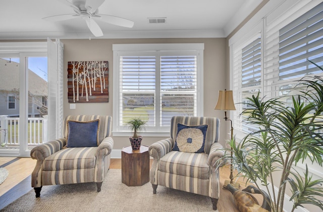 345 Turnstone St, Mount Pleasant, SC 29464 - living area featuring a ceiling fan, wood finished floors, baseboards, visible vents, and ornamental molding
