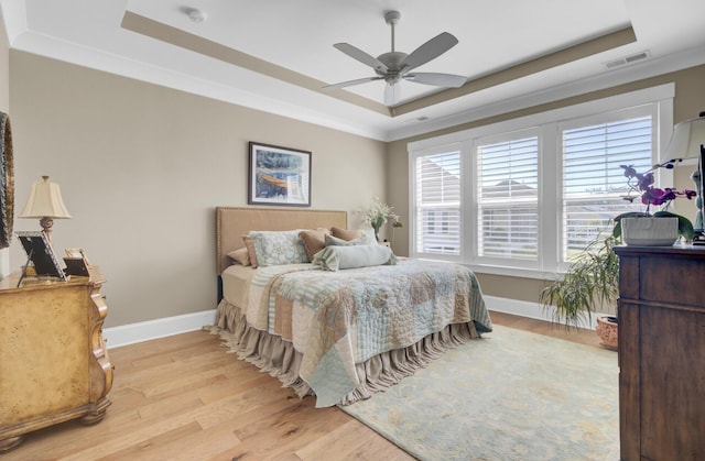 345 Turnstone St, Mount Pleasant, SC 29464 - bedroom with light wood-style flooring, a tray ceiling, baseboards, and visible vents