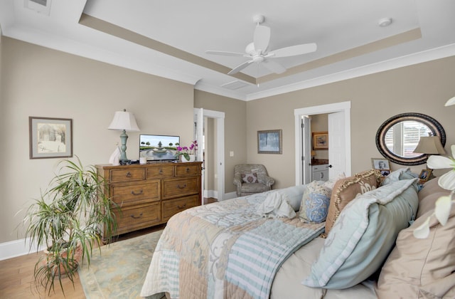 345 Turnstone St, Mount Pleasant, SC 29464 - bedroom featuring baseboards, wood finished floors, crown molding, and a raised ceiling
