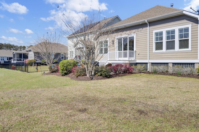 345 Turnstone St, Mount Pleasant, SC 29464 - rear view of house featuring a shingled roof, fence, and a lawn