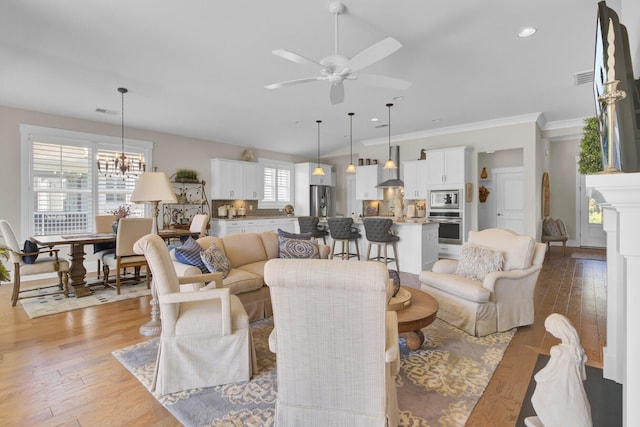 345 Turnstone St, Mount Pleasant, SC 29464 - living room with ceiling fan with notable chandelier, visible vents, light wood-style floors, and ornamental molding