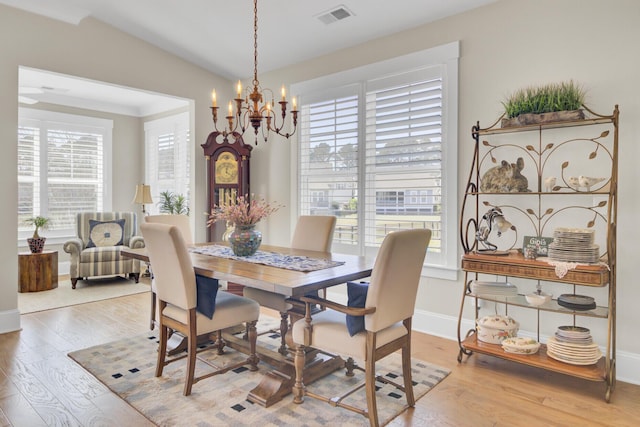 345 Turnstone St, Mount Pleasant, SC 29464 - dining room featuring an inviting chandelier, a healthy amount of sunlight, light wood finished floors, and visible vents