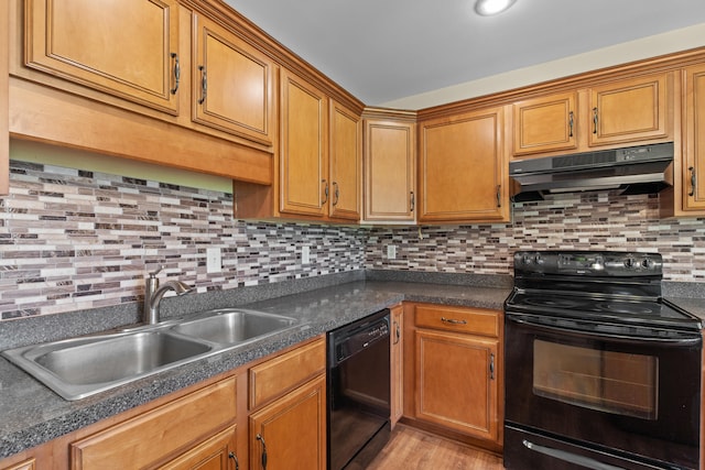 331 Kinard St, Orangeburg, SC 29118 - kitchen featuring black appliances, under cabinet range hood, dark countertops, backsplash, and light wood-style floors
