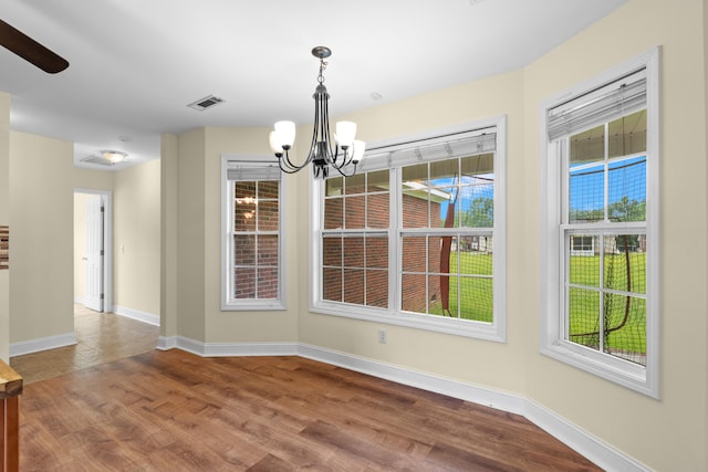 331 Kinard St, Orangeburg, SC 29118 - unfurnished dining area with a chandelier, plenty of natural light, wood finished floors, and ceiling fan
