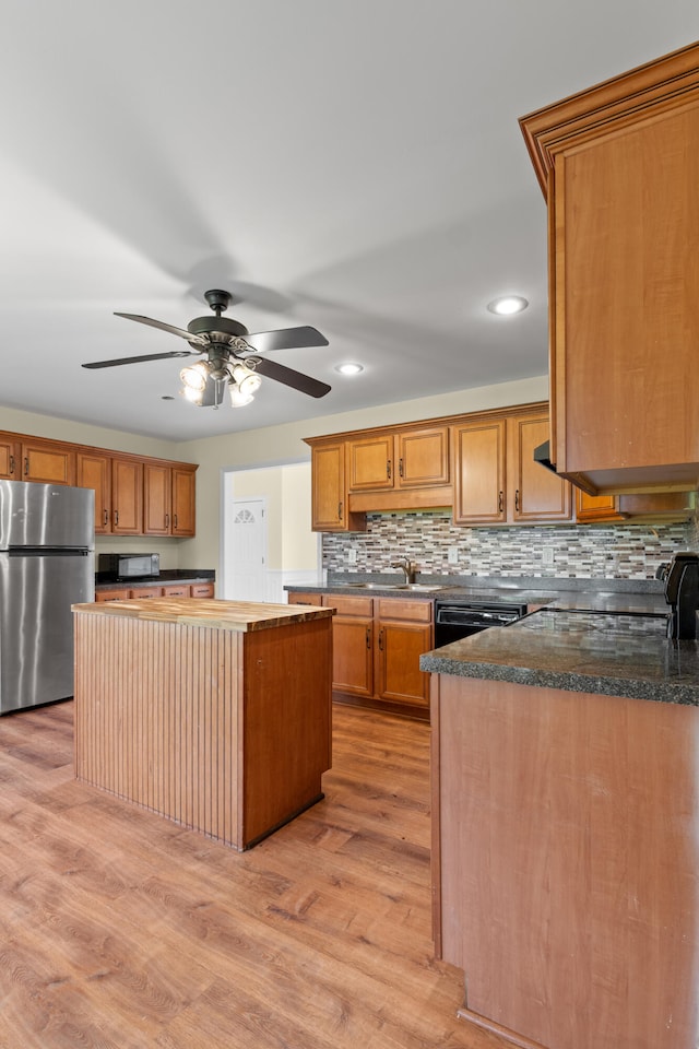 331 Kinard St, Orangeburg, SC 29118 - kitchen featuring black appliances, ceiling fan, a center island, light wood-style flooring, and tasteful backsplash