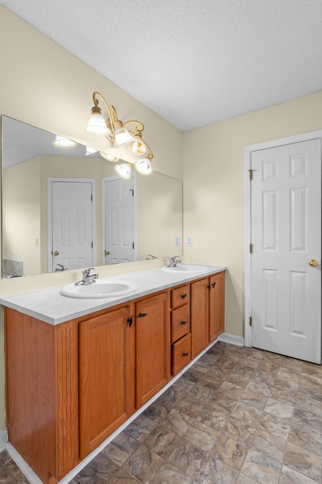 331 Kinard St, Orangeburg, SC 29118 - bathroom featuring double vanity, stone finish flooring, and a textured ceiling