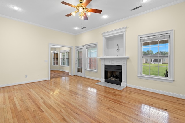 331 Kinard St, Orangeburg, SC 29118 - unfurnished living room with a fireplace with flush hearth, light wood-type flooring, ornamental molding, a chandelier, and ceiling fan