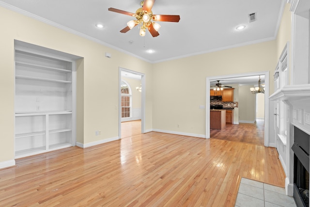 331 Kinard St, Orangeburg, SC 29118 - unfurnished living room with a fireplace with flush hearth, ceiling fan, light wood-style floors, ornamental molding, and built in shelves