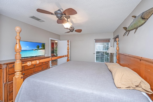 bedroom with a textured ceiling and ceiling fan