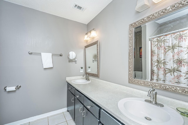 bathroom with a shower with curtain, a textured ceiling, tile patterned floors, and vanity