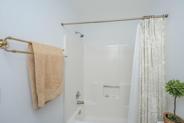 bathroom with shower / bath combo with shower curtain