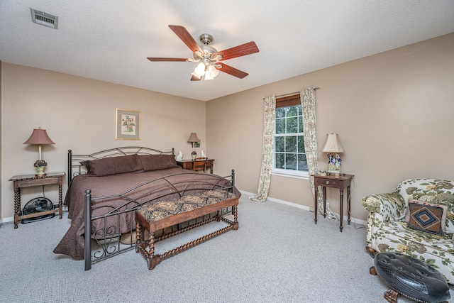 bedroom featuring carpet flooring, a textured ceiling, and ceiling fan