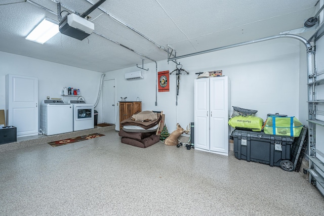 garage featuring washer and dryer, a wall unit AC, and a garage door opener