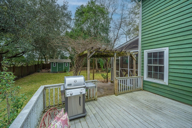 deck with grilling area, a storage unit, a lawn, and a pergola