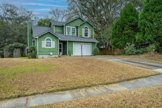 view of front property with a front yard and a garage